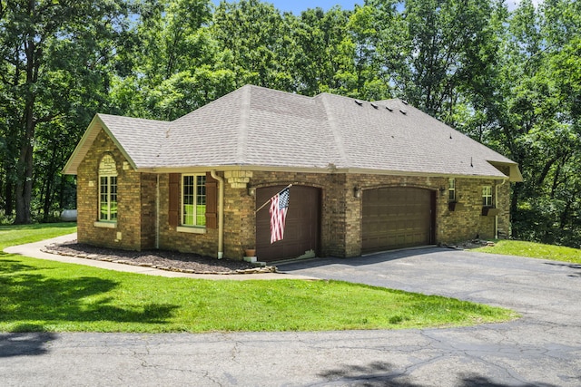 2504 W Fox Fire Ct, Nixa, MO 65714 - view of front of house featuring roof with shingles, an attached garage, asphalt driveway, and a front lawn