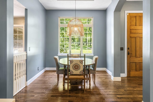 2504 W Fox Fire Ct, Nixa, MO 65714 - dining room with dark wood finished floors, a chandelier, and arched walkways