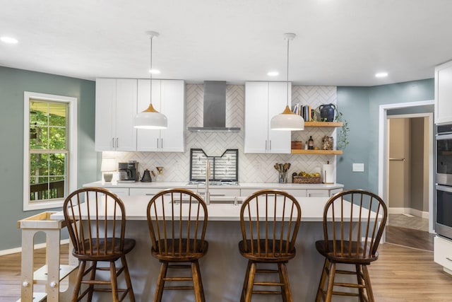 2504 W Fox Fire Ct, Nixa, MO 65714 - kitchen with wall chimney exhaust hood, tasteful backsplash, light wood-style floors, white cabinets, and recessed lighting