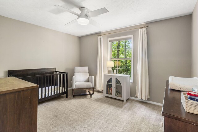 2504 W Fox Fire Ct, Nixa, MO 65714 - carpeted bedroom with a crib and a ceiling fan