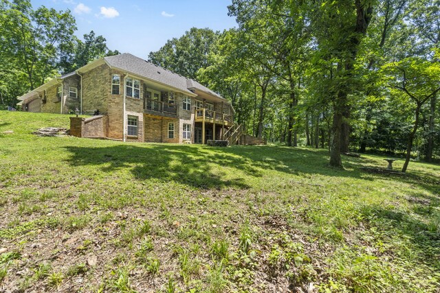 2504 W Fox Fire Ct, Nixa, MO 65714 - rear view of house featuring a yard, a deck, and brick siding