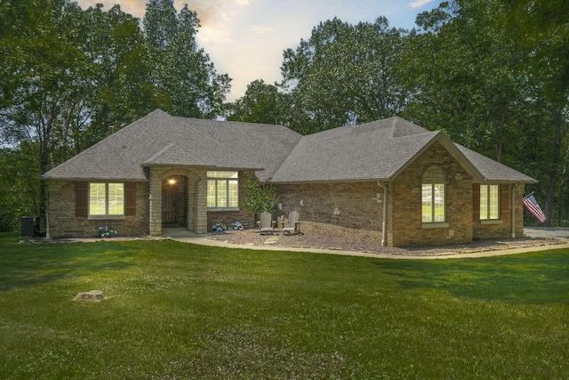 2504 W Fox Fire Ct, Nixa, MO 65714 - view of front of property featuring a lawn, roof with shingles, and brick siding