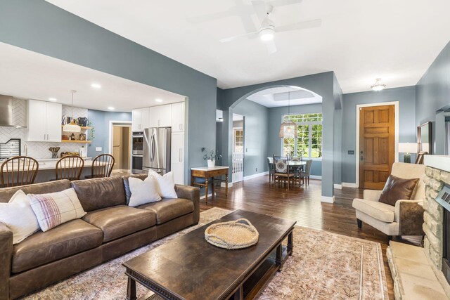 2504 W Fox Fire Ct, Nixa, MO 65714 - living room with arched walkways, wood finished floors, and ceiling fan