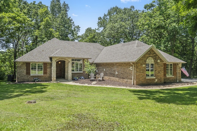 2504 W Fox Fire Ct, Nixa, MO 65714 - view of front of house featuring a front yard, brick siding, and a shingled roof