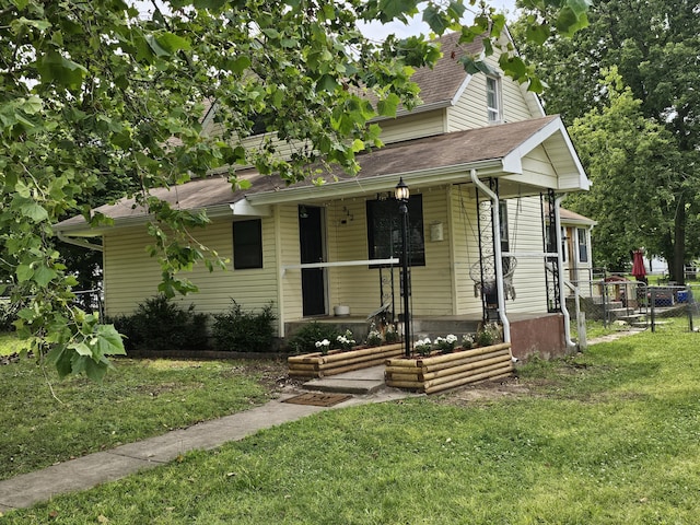 312 W Locust St, Aurora, MO 65605 - view of front facade featuring a porch and roof with shingles