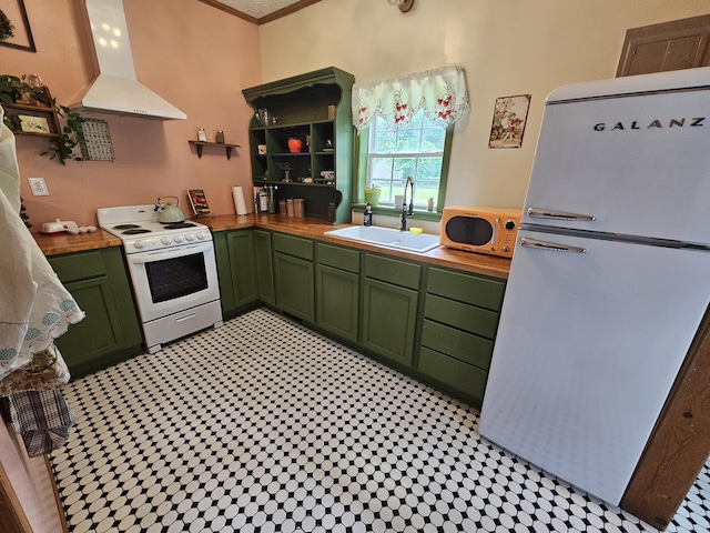 312 W Locust St, Aurora, MO 65605 - kitchen featuring green cabinets, wall chimney exhaust hood, white appliances, light flooring, and wood counters