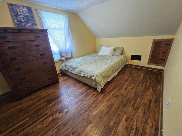 312 W Locust St, Aurora, MO 65605 - bedroom featuring lofted ceiling, dark wood-style floors, and a textured ceiling