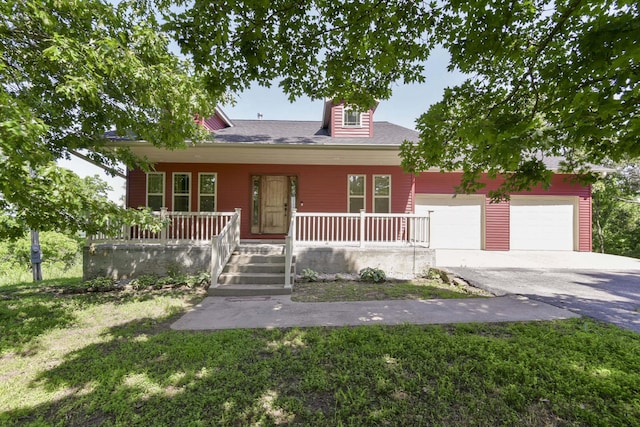 18054 State Highway 39, Aurora, MO 65605 - view of front of property with a porch, asphalt driveway, a garage, and a front lawn
