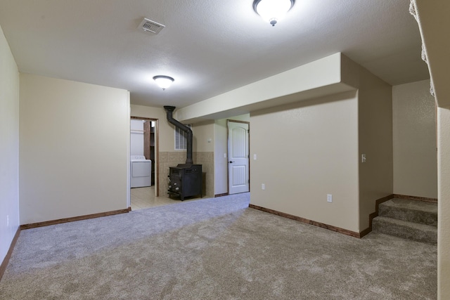 18054 State Highway 39, Aurora, MO 65605 - finished basement featuring washer / dryer, a wood stove, carpet flooring, and stairs