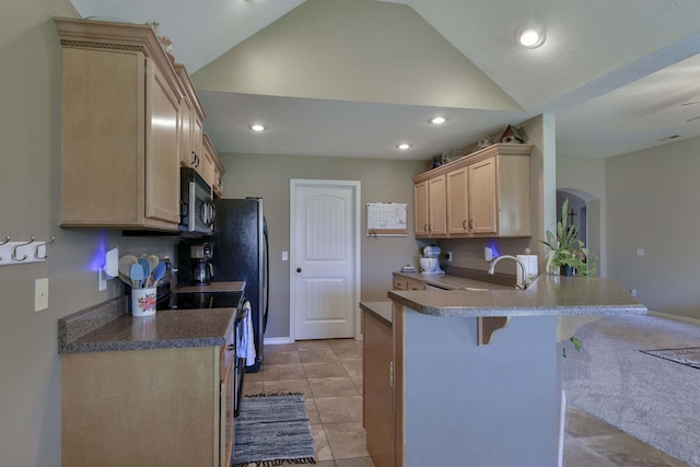 105 Deer Run, Willard, MO 65781 - kitchen with black microwave, light brown cabinets, a kitchen breakfast bar, lofted ceiling, and arched walkways