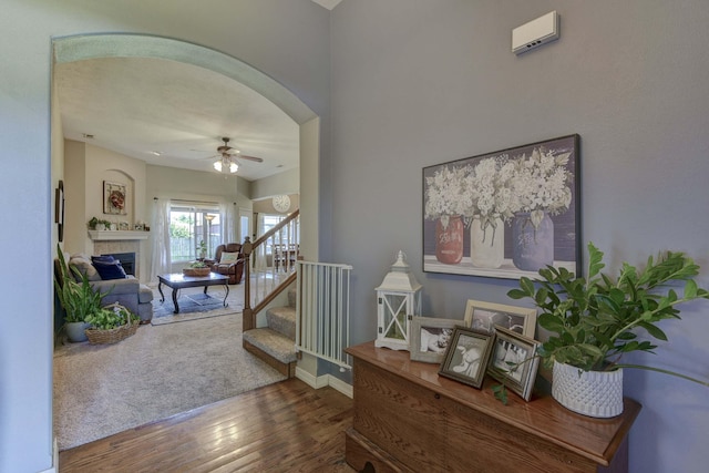 105 Deer Run, Willard, MO 65781 - stairs featuring wood finished floors, arched walkways, ceiling fan, and a fireplace
