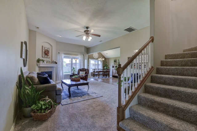 105 Deer Run, Willard, MO 65781 - carpeted living room featuring stairway, ceiling fan, a tile fireplace, and a chandelier
