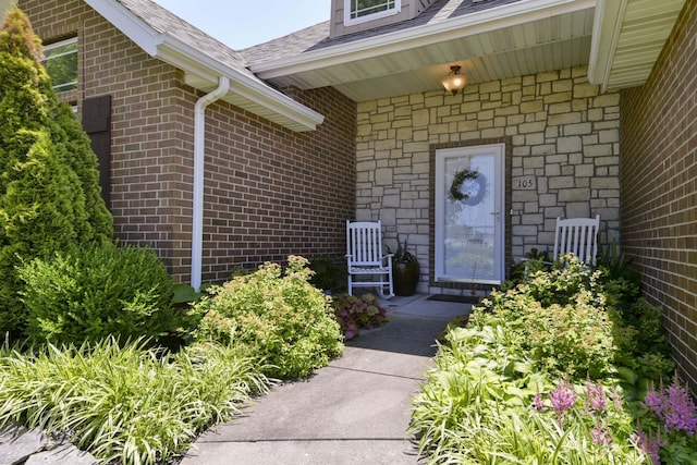 105 Deer Run, Willard, MO 65781 - property entrance featuring a shingled roof, stone siding, and brick siding
