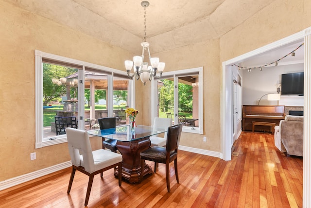 3702 E Dartmoor Ct, Springfield, MO 65802 - dining area featuring a chandelier, light wood-style flooring, and a textured wall