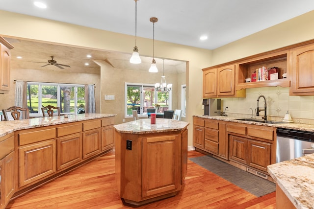 3702 E Dartmoor Ct, Springfield, MO 65802 - kitchen with stainless steel dishwasher, light wood-type flooring, a center island, light stone countertops, and recessed lighting