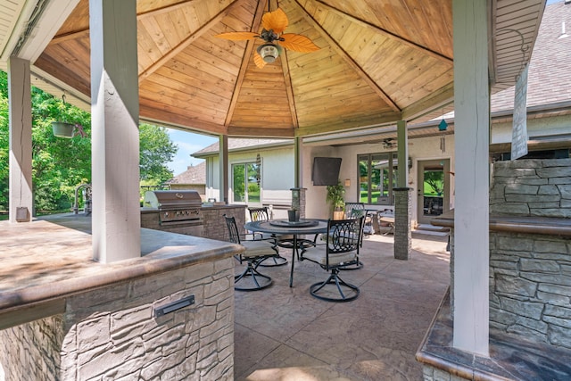 3702 E Dartmoor Ct, Springfield, MO 65802 - view of patio featuring an outdoor kitchen, ceiling fan, outdoor dining area, and a gazebo