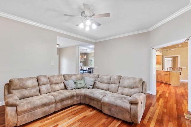 3702 E Dartmoor Ct, Springfield, MO 65802 - living room with light wood-style flooring, crown molding, and ceiling fan