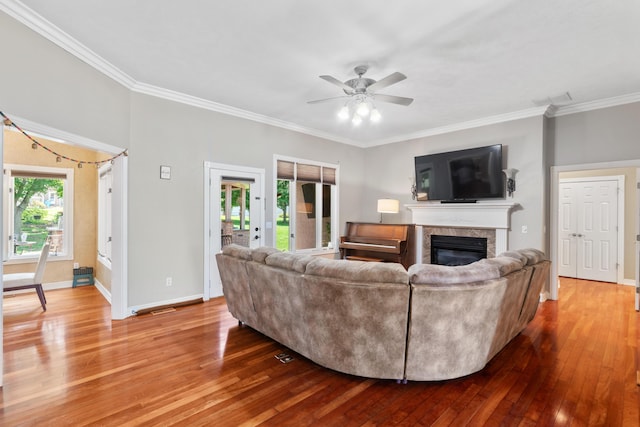 3702 E Dartmoor Ct, Springfield, MO 65802 - living room with wood-type flooring, crown molding, a glass covered fireplace, and a ceiling fan