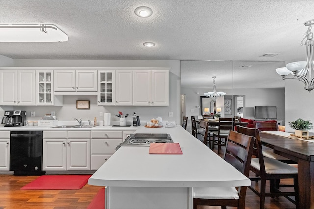 161 Avondale Dr Unit 1, Branson, MO 65616 - kitchen featuring dishwasher, a chandelier, dark wood-type flooring, light countertops, and a textured ceiling