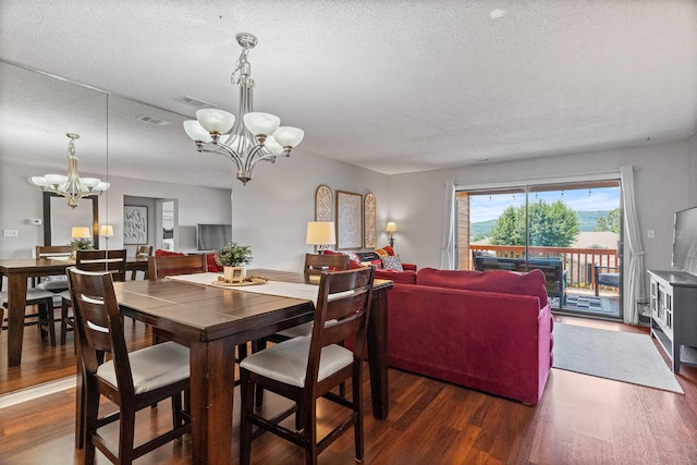 161 Avondale Dr Unit 1, Branson, MO 65616 - dining space with a chandelier, wood finished floors, and a textured ceiling