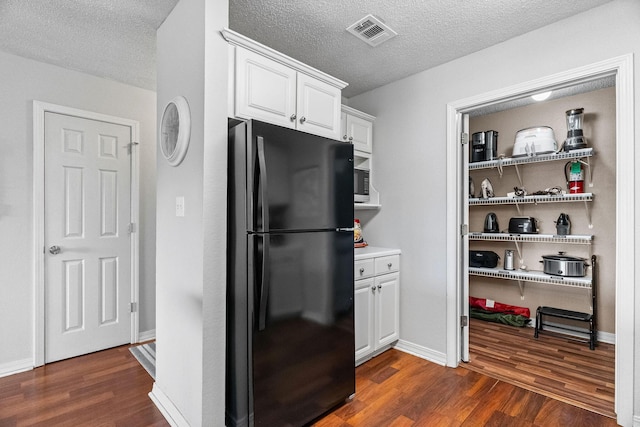161 Avondale Dr Unit 1, Branson, MO 65616 - kitchen featuring freestanding refrigerator, dark wood-type flooring, white cabinetry, a textured ceiling, and light countertops