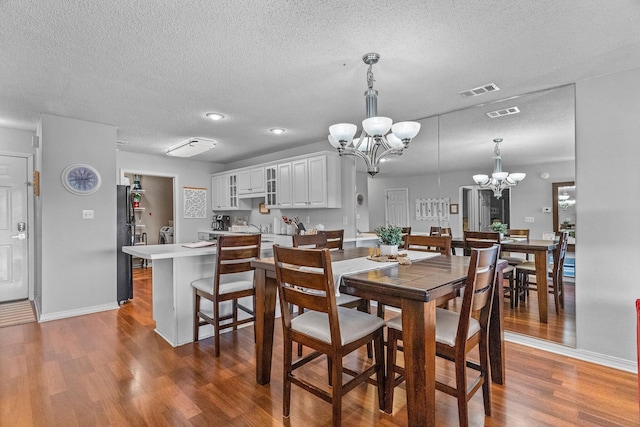 161 Avondale Dr Unit 1, Branson, MO 65616 - dining room with a chandelier, wood finished floors, and a textured ceiling