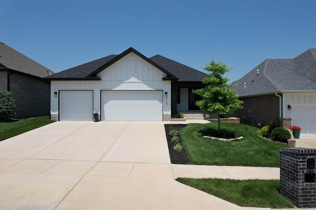 3733 E Hutcheson Ave, Springfield, MO 65802 - single story home featuring board and batten siding, a front lawn, an attached garage, concrete driveway, and roof with shingles