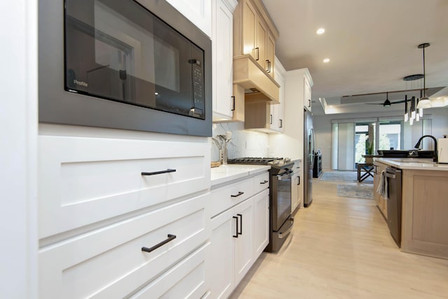 3733 E Hutcheson Ave, Springfield, MO 65802 - kitchen featuring stainless steel appliances, light wood-type flooring, recessed lighting, hanging light fixtures, and white cabinetry
