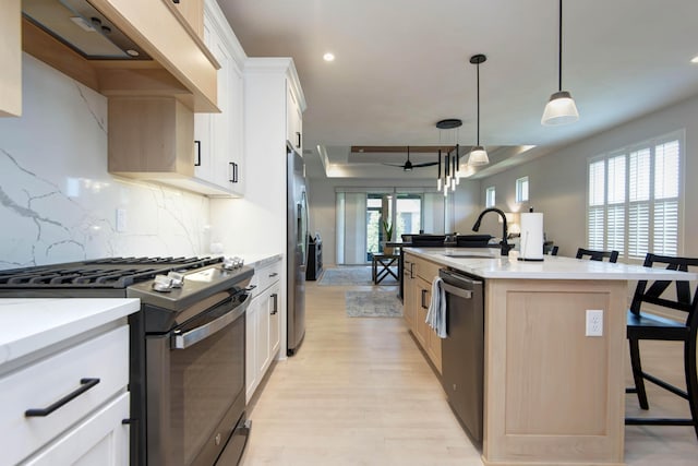 3733 E Hutcheson Ave, Springfield, MO 65802 - kitchen with range with gas cooktop, dishwashing machine, stainless steel fridge with ice dispenser, a kitchen bar, and decorative backsplash