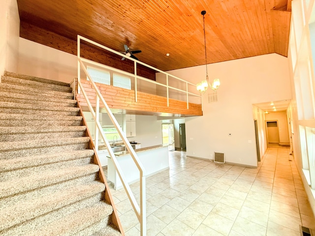 48 Galatians Ln, Reeds Spring, MO 65737 - stairs featuring a towering ceiling, wood ceiling, tile patterned floors, ceiling fan, and a chandelier