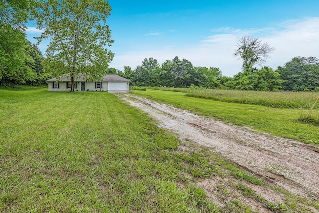3936 S 77th Rd, Dunnegan, MO 65640 - view of green lawn featuring dirt driveway and an attached garage