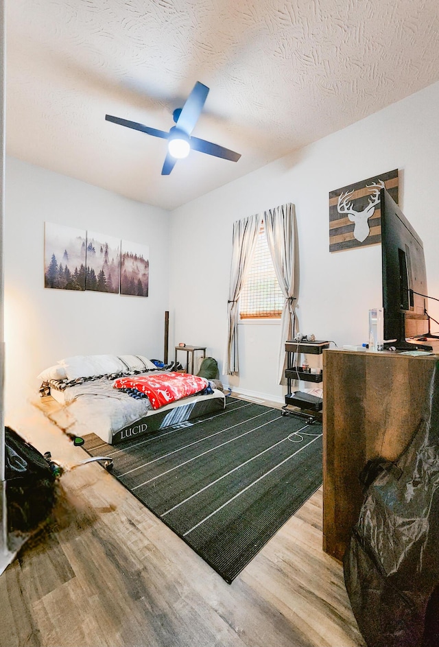 1305 N Main Ave, Springfield, MO 65802 - bedroom featuring wood finished floors, a textured ceiling, and ceiling fan
