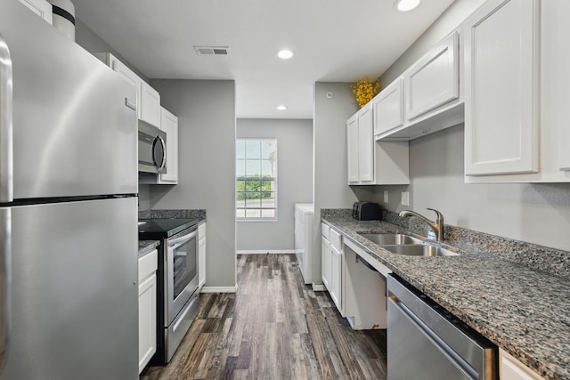 2951 Vineyards Pkwy Unit 34-2, Branson, MO 65616 - kitchen featuring stainless steel appliances, dark wood-style floors, white cabinetry, dark stone counters, and recessed lighting