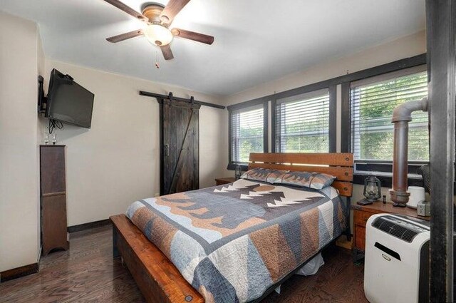 31 Mulberry Ln, Buffalo, MO 65622 - bedroom with a barn door, wood finished floors, and a ceiling fan
