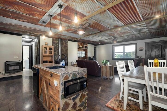 31 Mulberry Ln, Buffalo, MO 65622 - kitchen with heating unit, a ceiling fan, stainless steel microwave, a center island with sink, and wooden ceiling