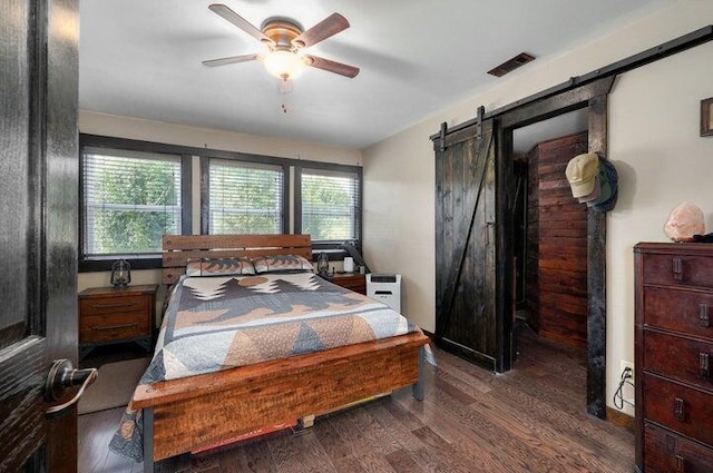 31 Mulberry Ln, Buffalo, MO 65622 - bedroom with a barn door, wood finished floors, and a ceiling fan