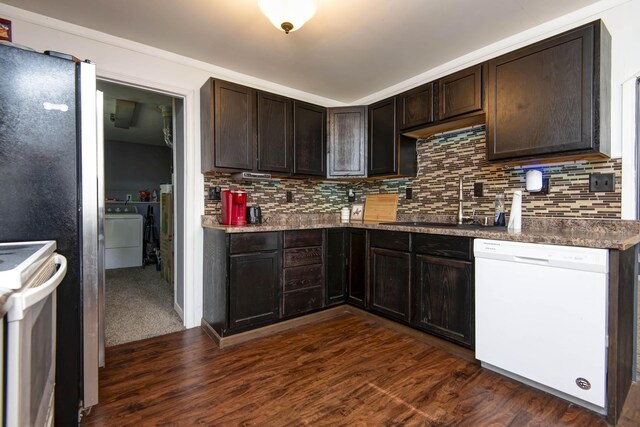 2718 E Blaine St, Springfield, MO 65803 - kitchen featuring white appliances, dark brown cabinetry, washer / clothes dryer, decorative backsplash, and dark wood finished floors