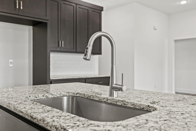 1305 W Ragweed Ct, Ozark, MO 65721 - kitchen featuring light stone counters, dark brown cabinetry, and recessed lighting
