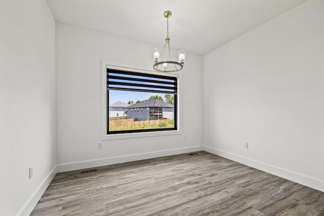 1305 W Ragweed Ct, Ozark, MO 65721 - unfurnished room with a chandelier and wood finished floors