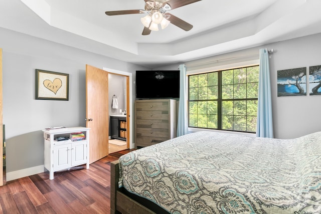 241 Sage Rd, Ozark, MO 65721 - bedroom with a raised ceiling, dark wood-style floors, a ceiling fan, and connected bathroom