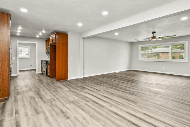7047 W Lone Oak St, Springfield, MO 65803 - unfurnished living room with recessed lighting, wood finished floors, healthy amount of natural light, and a ceiling fan