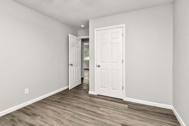 7047 W Lone Oak St, Springfield, MO 65803 - unfurnished bedroom with wood finished floors and baseboards