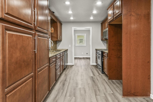 7047 W Lone Oak St, Springfield, MO 65803 - kitchen featuring appliances with stainless steel finishes, light stone countertops, light wood-type flooring, and recessed lighting