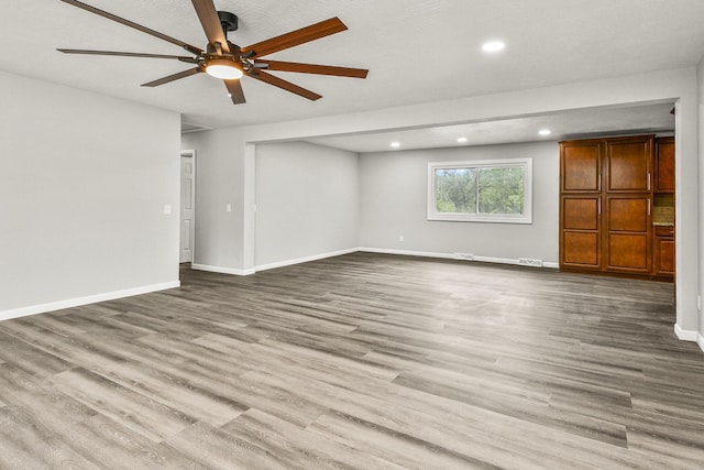 7047 W Lone Oak St, Springfield, MO 65803 - unfurnished living room featuring a ceiling fan, recessed lighting, and wood finished floors