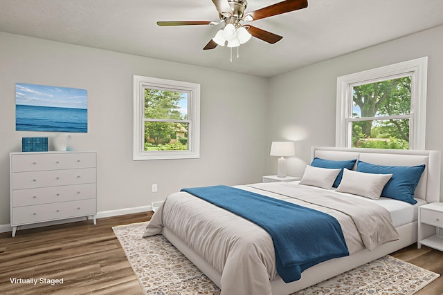 7047 W Lone Oak St, Springfield, MO 65803 - bedroom featuring multiple windows, wood finished floors, and a ceiling fan