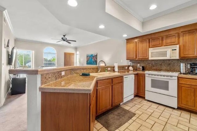 200 Glory Rd Unit B6, Branson, MO 65616 - kitchen featuring white appliances, a peninsula, backsplash, light countertops, and ornamental molding