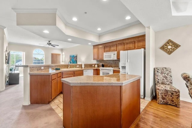 200 Glory Rd Unit B6, Branson, MO 65616 - kitchen featuring white appliances, crown molding, light countertops, a peninsula, and recessed lighting