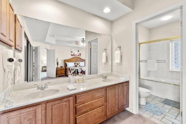 200 Glory Rd Unit B6, Branson, MO 65616 - full bath featuring connected bathroom, double vanity, enclosed tub / shower combo, and ceiling fan
