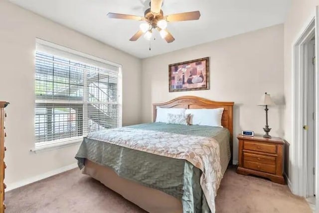200 Glory Rd Unit B6, Branson, MO 65616 - carpeted bedroom featuring multiple windows and ceiling fan
