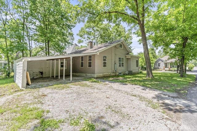 922 W Elm St, Springfield, MO 65806 - view of front of home with a chimney, driveway, and an attached carport